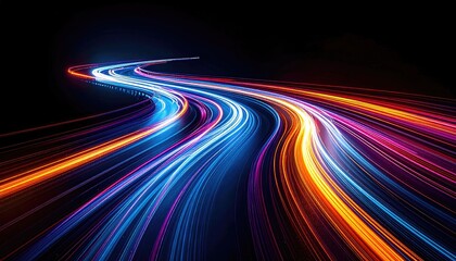 Long exposure shot of illuminated vehicle trails curving along a dark asphalt road