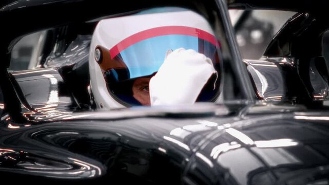 A fast racing car stands in the pitlane garage before the race