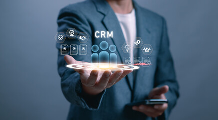 Businessman Hand with Human Icon on Virtual Screen Showing Business Organization Online Marketing Strategy or Goal.CRM, Customer Relationship Management, Customer Service, Digital Marketing Concept