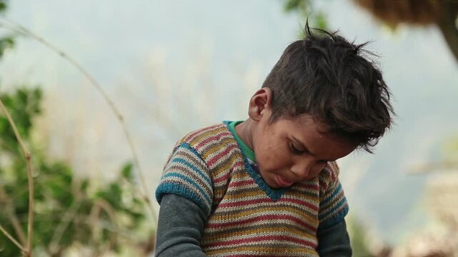 A rural Indian boy eats simple food with bread and tea while sitting outdoors in an Uttarakhand village. The scene reflects poverty, daily nutrition, childhood, and village lifestyle.