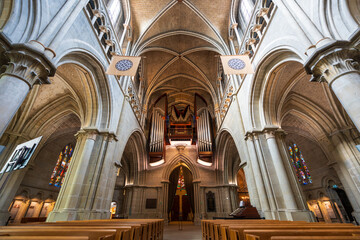 Lausanne, Vaud, Switzerland - November 01, 2025 : Lausanne Cathedral Gothic interior with great pipe organ and vaulted ceiling.