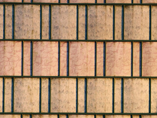 Barbed wire fence with old privacy strips, background