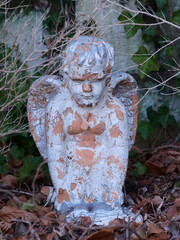Angel statue in the cemetery, the surface of the statue has flaked off due to weathering