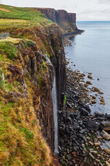 Kilt Rock waterfall cascading over coastal cliffs Isle of Skye Scotland