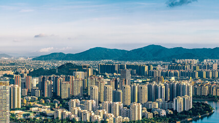 Aerial view of the dense residential buildings and mountain scenery in Zhuhai.