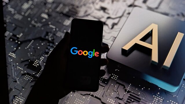 Hand holding smartphone with Google logo next to AI chip on circuit board