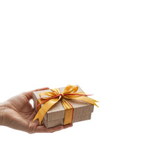 Hand holding a small gift box with a golden ribbon