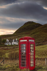 Red telephone booth next to the A855 road in Brogaig village at the foot of the Quiraing landform, old K6 model still operational. Skye-Scotland-177