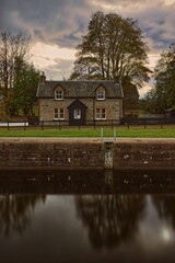Stone and slate house beside the fifth lock of the five-step stairs that haul ships from Loch Ness to the Caledonian Canal. Fort Augustus-Scotland-198