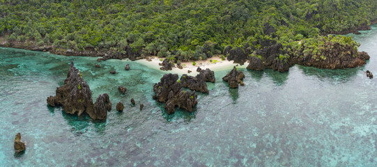 Rugged rock islands, composed of ancient, uplifted reefs, rise from the seascape in Misool, Indonesia. This region harbors spectacular marine biological diversity and is a popular destination for dive
