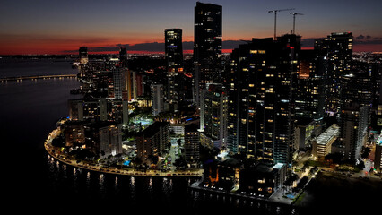 Naklejka premium Miami Skyline At Miami In Florida United States. Illuminated City. Night City Scenery. Downtown District. Miami Skyline In Florida United States. Stunning Cityscape.