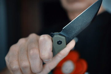  hand gripping a folding knife