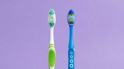 Two toothbrushes on purple background green blue