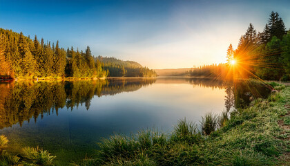 Idyllic Lake Sunrise With Warm Sunbeams And Reflective Forest Surroundings Beautiful Landscape For Nature Tourism And Conservation Awareness