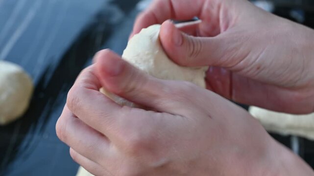 Shaping a Bun from Raw Yeast Dough in Female Hands at Home