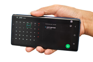 Person Holding Black Smartphone With Keyboard App Open White Background