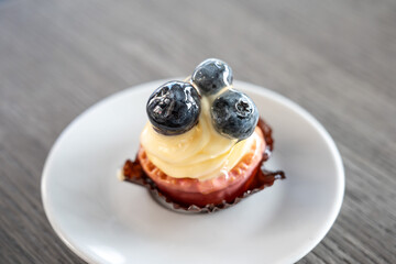 Pastry dessert topped with creamy filling and fresh blueberries, styled on a plate in Il-Gżira, highlighting texture and Mediterranean patisserie charm Il-Gżira, Malta, 6 DEC 2025.