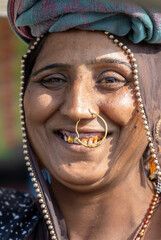 rural tribal woman smiling face with gold nose ring in ethnic traditional attire