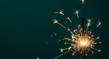 Close-up of sparkler emitting bright, radial sparks against dark backdrop, representative of festive celebration, joy and memorable moment, free space