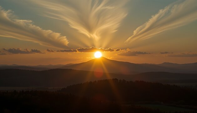 A breathtaking view of a sunset over rolling hills. A large, radiant sun sits just above the horizon, casting a warm glow across the landscape