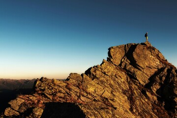 man on top of mountain © MugiwaraYAAA