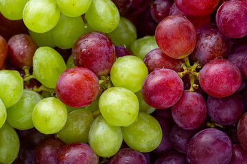 Close-up of red and green grapes, focusing on the texture of the fruit