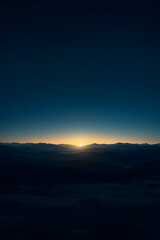 Fototapeta premium Sunrise over misty mountain valley