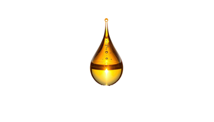 Translucent golden drop with small bubbles on a stark black background