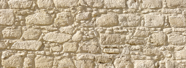 Stone wall texture closeup showing old rugged masonry