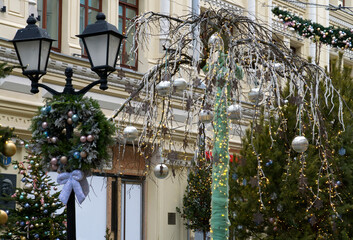 New Year's Eve decoration of street. Christmas trees with balls on branches.