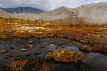 Autumn Mountain Landscape With Lake, Golden Foliage, And Calm Sky Above Rolling Hills