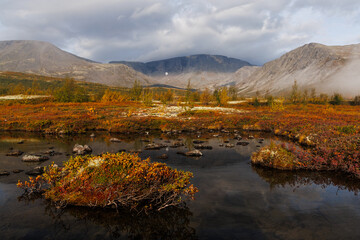 Autumn Mountain Landscape With Lake, Colorful Foliage, Rocks, and Misty Sky Above