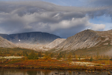 Autumn Mist Over Mountain Valley With Foggy Trees And Calm Stream