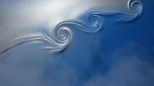 Serene blue sky with swirling silver clouds viewed from below on a calm day