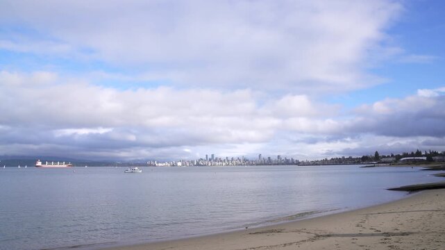 English Bay Cityscape Cloudscape 4K UHD.The view of the Vancouver skyline and clouds from Jericho Beach on English Bay. Vancouver, British Columbia, Canada. 4K, UHD.
