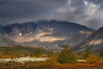 Autumn Mountain Valley Landscape With Dark Clouds Over Vibrant Tundra and Lake