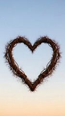 Heartshaped wreath against clear blue sky at sunset