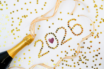 Waving shiny ribbons with gold stars pink heart on a white background and a bottle of festive champagne