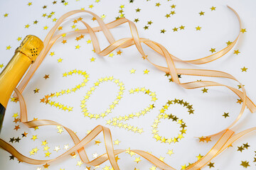 2026 scene captures a moment of celebration and joy. Bottle of sparkling wine is poised to be opened, surrounded small golden stars that create a festive vibe.