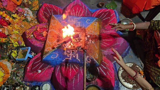 Flames rise from a decorated havan kund as priests conduct a sacred Hindu ritual, highlighting spirituality, faith, and cultural heritage.