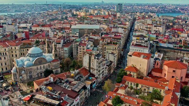 Daytime aerial view of Istanbul&rsquo;s dense urban texture. Historic buildings, narrow streets, and modern city life blend together, with the distant sea and coastline adding depth to the metropolitan scen