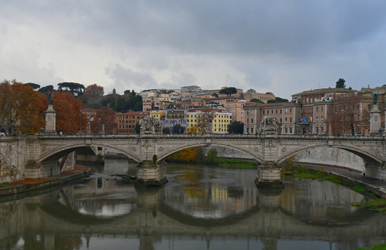 Scenic view of Ponte Sant'Angelo spanning the Tiber River in Rome, Italy, with historic architecture lining the waterfront. One of Rome's most photographed locations and a popular European travel dest