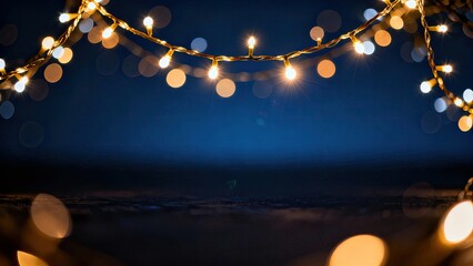 Warm string lights suspended over a tranquil night seascape creating a dreamy, cozy mood with soft bokeh glow above the dark blue ocean and quiet shore