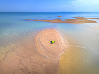 a surfer with a board in the shallows