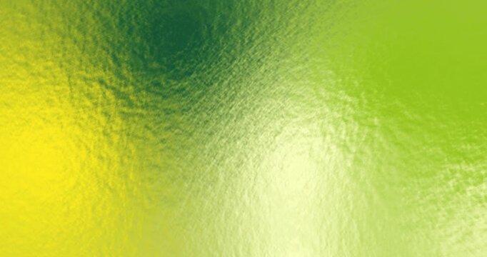 Super slow motion abstract water surface on a light yellow, dark green, orange & blue background.