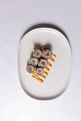 Sushi serving on white plate, top view