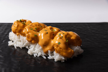 Nigiri sushi topped with crispy pieces coated in creamy spicy sauce