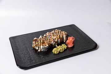 Sushi rolls topped with creamy mayonnaise and teriyaki sauce