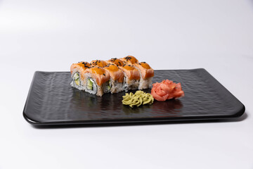 Salmon skin sushi roll served on a black stone