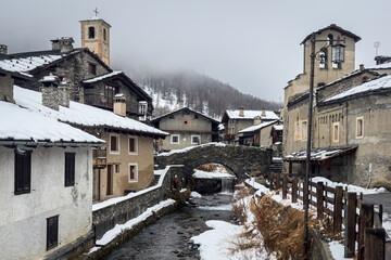 View of Chianale, a typical alpine village covered with snow during winter, Piedmont region, Italy